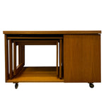 Load image into Gallery viewer, Set of wooden nesting tables on wheels with a white background
