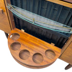 Load image into Gallery viewer, Close-up of a wooden bar or cabinet interior with a glass shelf, brass rod, and a curved wooden tray with four circular cutouts extending outward.
