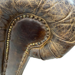 Load image into Gallery viewer, Close-up of a distressed dark brown leather armrest with gold-toned nailhead trim and visible crackled wear on the leather surface.
