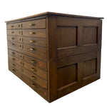 Load image into Gallery viewer, A vintage dark brown wooden chest of drawers with multiple drawers featuring brass handles and red numbering, shown on a plain white background.
