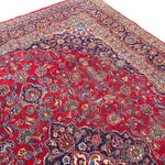 Load image into Gallery viewer, Close-up of a red patterned rug with intricate designs

