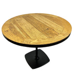 Load image into Gallery viewer, Round wooden table with a black base on a white background
