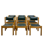 Load image into Gallery viewer, Eight wooden dining chairs with dark green upholstered seats and backs, arranged in two rows against a plain white background.
