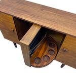 Load image into Gallery viewer, A mid-century modern wooden sideboard or credenza with a pull-out circular tray table inside an open cabinet, shown against a plain white background.
