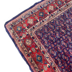 Load image into Gallery viewer, Close-up of a patterned rug with red, blue, and beige colors on a white background.

