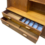 Load image into Gallery viewer, Close-up of a mid-century modern wooden desk or cabinet with two pull-out drawers. One drawer is open to reveal a built-in organizer tray lined with light blue fabric.
