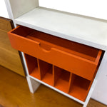 Load image into Gallery viewer, White shelf with an open orange drawer and compartments.

