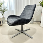 Load image into Gallery viewer, grey swivel office chair with curtains and plants
