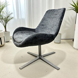 grey swivel office chair with curtains and plants