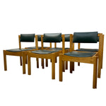 Load image into Gallery viewer, Six wooden dining chairs with black upholstered seats and backs, arranged in a group on a plain white background.
