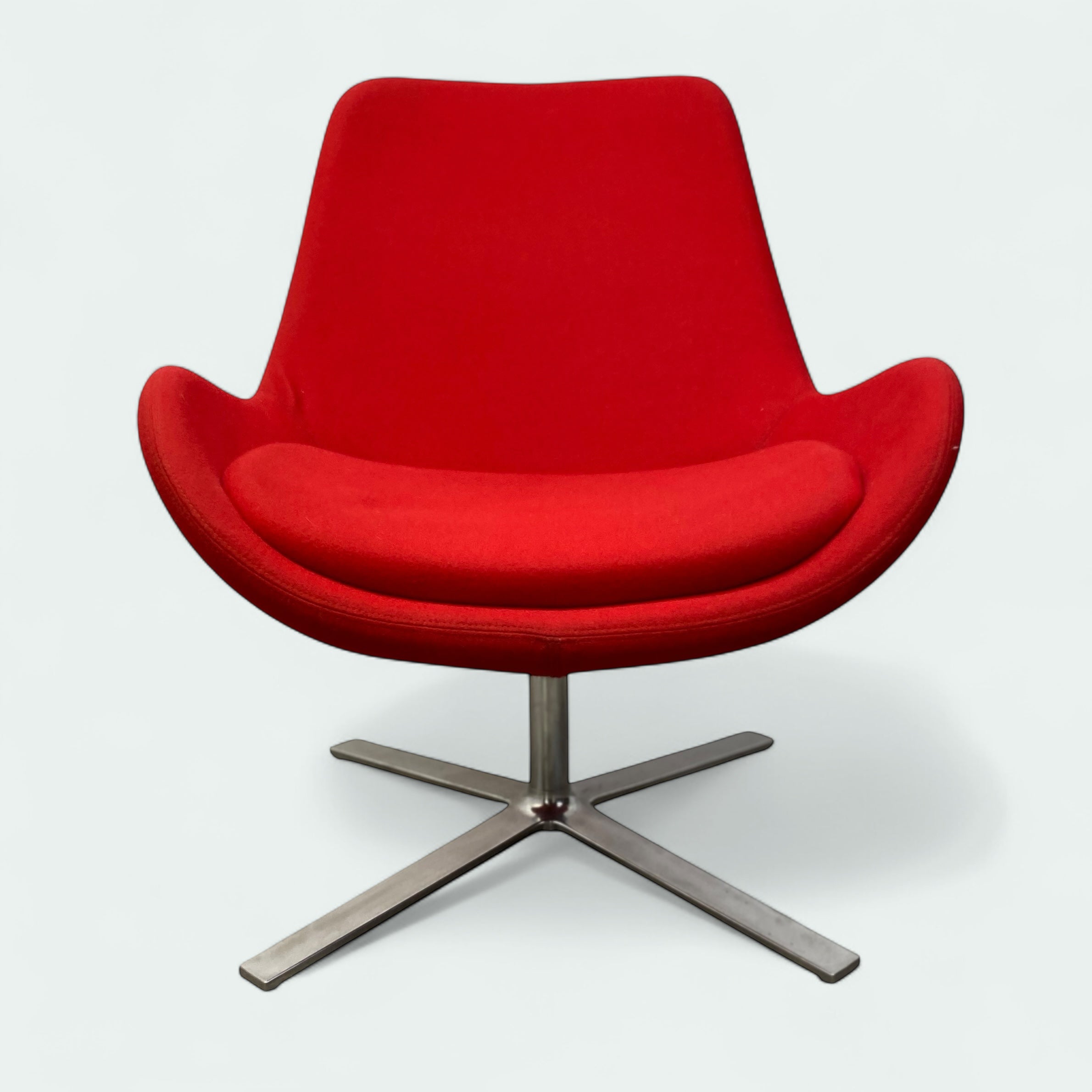 Red chair with a metal base on a white background