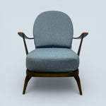 Load image into Gallery viewer, Blue armchair with wooden frame on a light gray background
