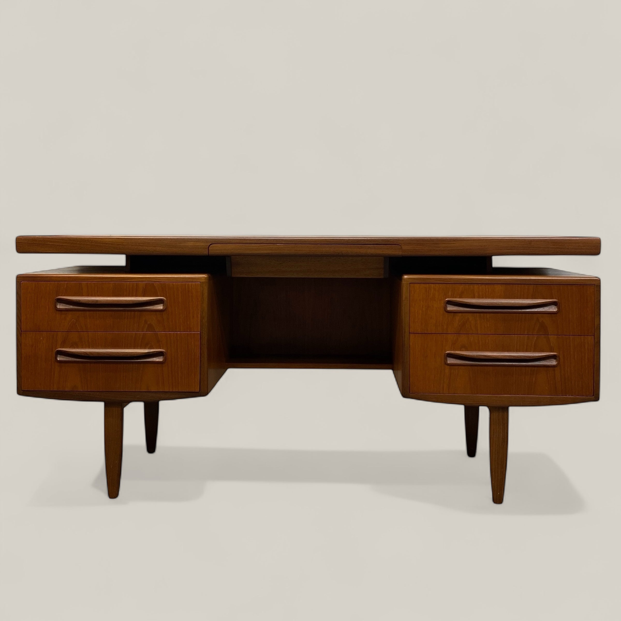 Wooden desk with drawers on a light gray background