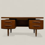 Load image into Gallery viewer, Wooden desk with drawers on a light gray background
