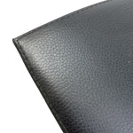 Load image into Gallery viewer, Close-up of a black pebbled leather surface with visible grain texture and a stitched edge on a white background.
