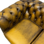 Load image into Gallery viewer, Close-up of a brown leather sofa with tufted backrest and armrest.
