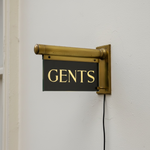 Load image into Gallery viewer, Gents sign on a white wall with brass bracket
