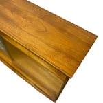 Load image into Gallery viewer, Close-up of a wooden cabinet or shelf with a warm medium-brown finish and visible wood grain, shown against a plain white background.
