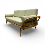 Load image into Gallery viewer, Sofa with wooden frame and green cushions on a white background
