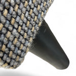 Load image into Gallery viewer, Close-up of a woven upholstered product corner with a black conical support leg on a white background.
