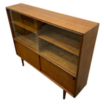 Load image into Gallery viewer, Mid-century modern wooden display cabinet with glass-front upper doors, open middle shelves, and lower sliding doors on a white background.
