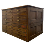 Load image into Gallery viewer, A vintage dark brown wooden storage chest with multiple drawers, brass handles, and red stamped numbers on the side, shown against a plain white background.
