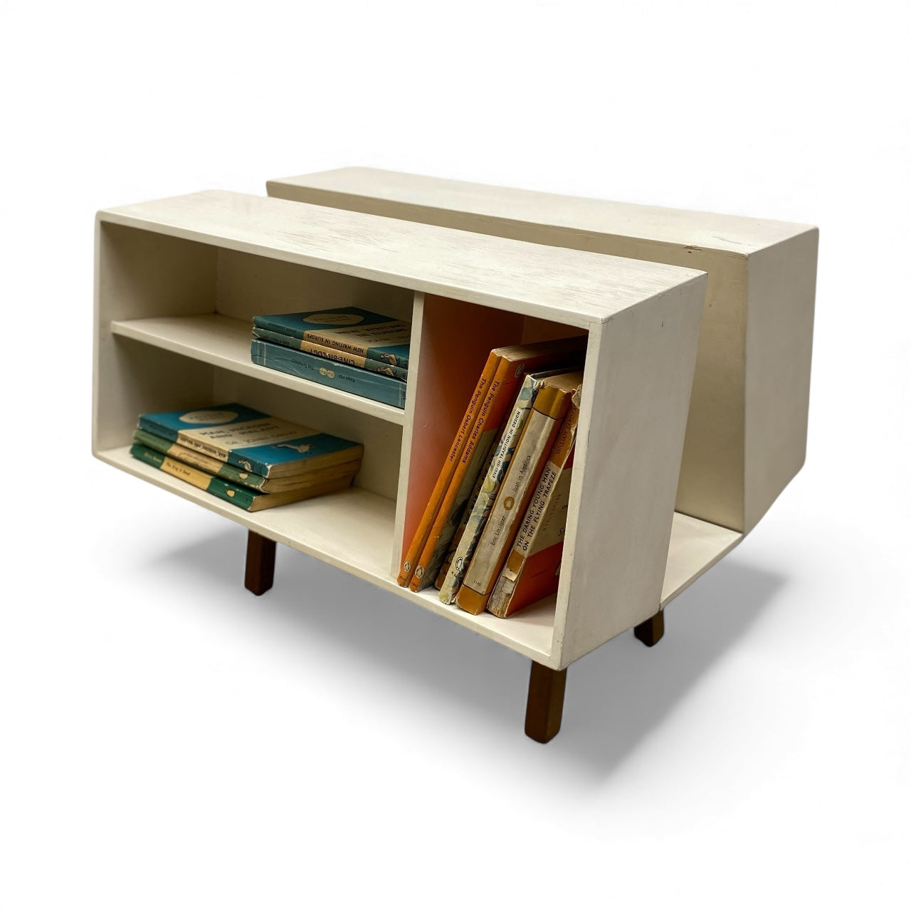 Light wooden bookshelf with books on a white background