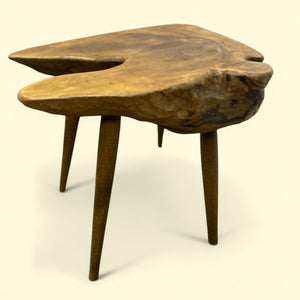Wooden side table with a natural, organic design on a beige background