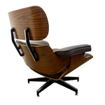 Load image into Gallery viewer, A mid-century modern lounge chair with a rich walnut wood grain shell, dark brown leather cushions, and a black five-star base, shown from a three-quarters angle on a white background.

