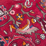 Load image into Gallery viewer, Close-up of a red patterned rug with intricate designs
