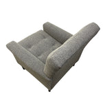 Load image into Gallery viewer, A gray upholstered armchair with a textured fabric, button tufting on the seat, and a high back, shown from an elevated angle against a plain white background.
