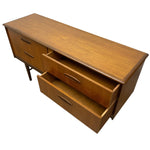 Load image into Gallery viewer, Mid-century modern wooden sideboard with a warm medium-brown finish, featuring three drawers on the left, two drawers on the right including one open, and slim metal handles, shown on a plain white background.
