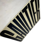 Load image into Gallery viewer, A close-up of a square metal sign with a silver-gray face and a black and cream diagonal striped side, featuring the word 'CAUTION' in bold black letters.
