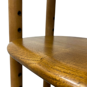 Close-up of a wooden chair seat with a white background