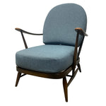 Load image into Gallery viewer, Blue upholstered armchair with wooden frame on a white background
