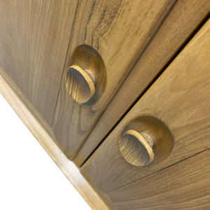 Close-up of wooden drawers with knobs on a white background