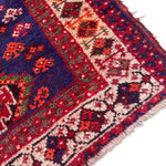 Load image into Gallery viewer, Close-up of a colorful patterned rug with red, blue, and beige colors.
