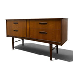 Load image into Gallery viewer, Mid-century modern wooden sideboard with four drawers, dark metal handles, and tapered legs, shown on a white background with a soft shadow.
