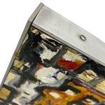 Load image into Gallery viewer, Close-up of a corner where a painting meets a metallic frame.
