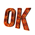 Load image into Gallery viewer, A pair of 3D marquee-style letters spelling 'OK', with warm orange-red metallic surfaces and small glowing light bulbs, isolated on a white background.
