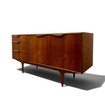 Load image into Gallery viewer, Mid-century modern wooden credenza with three drawers on the left and two larger doors on the right, finished in warm reddish-brown wood with tapered legs, shown on a white background with a soft shadow.
