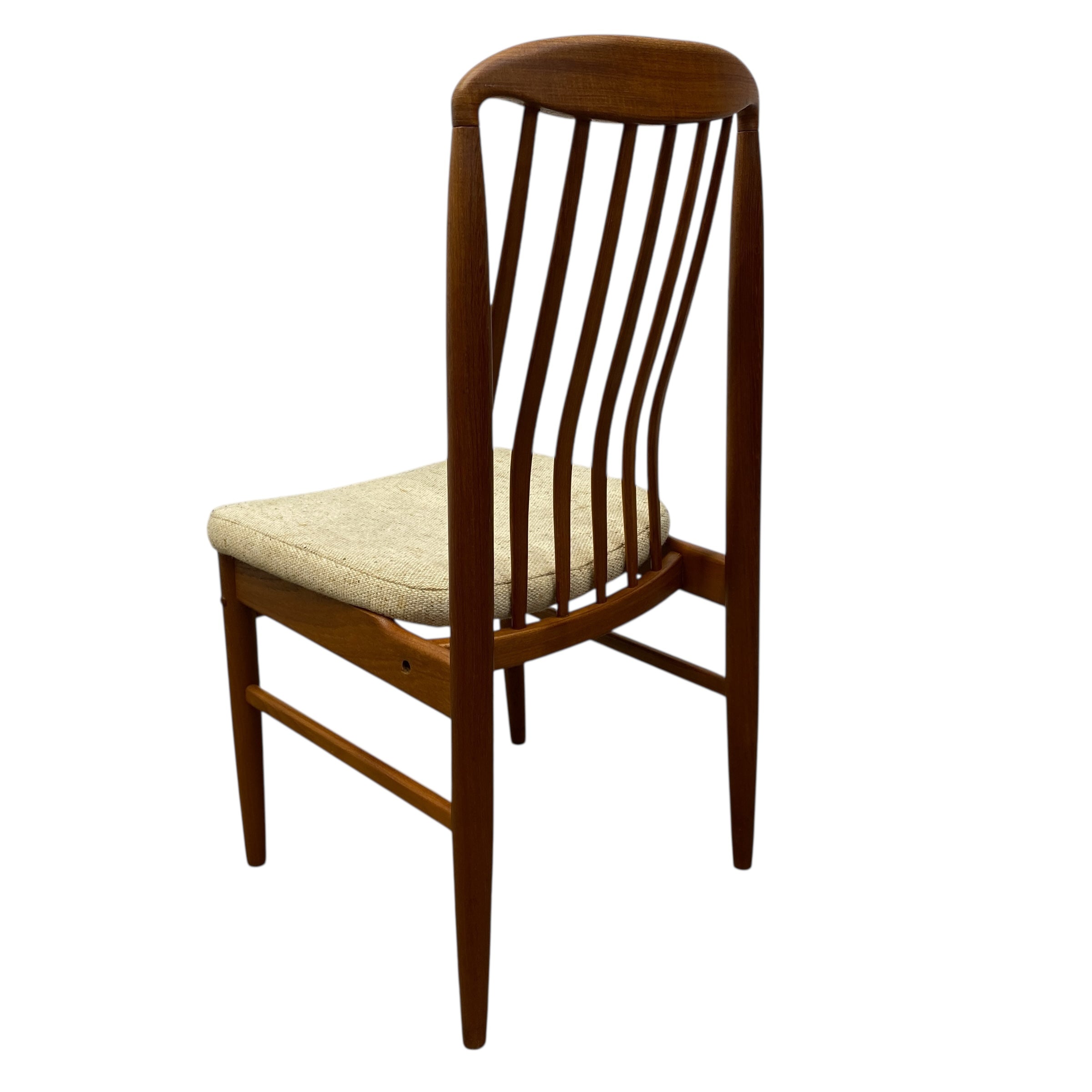 Wooden chair with a beige cushion on a white background