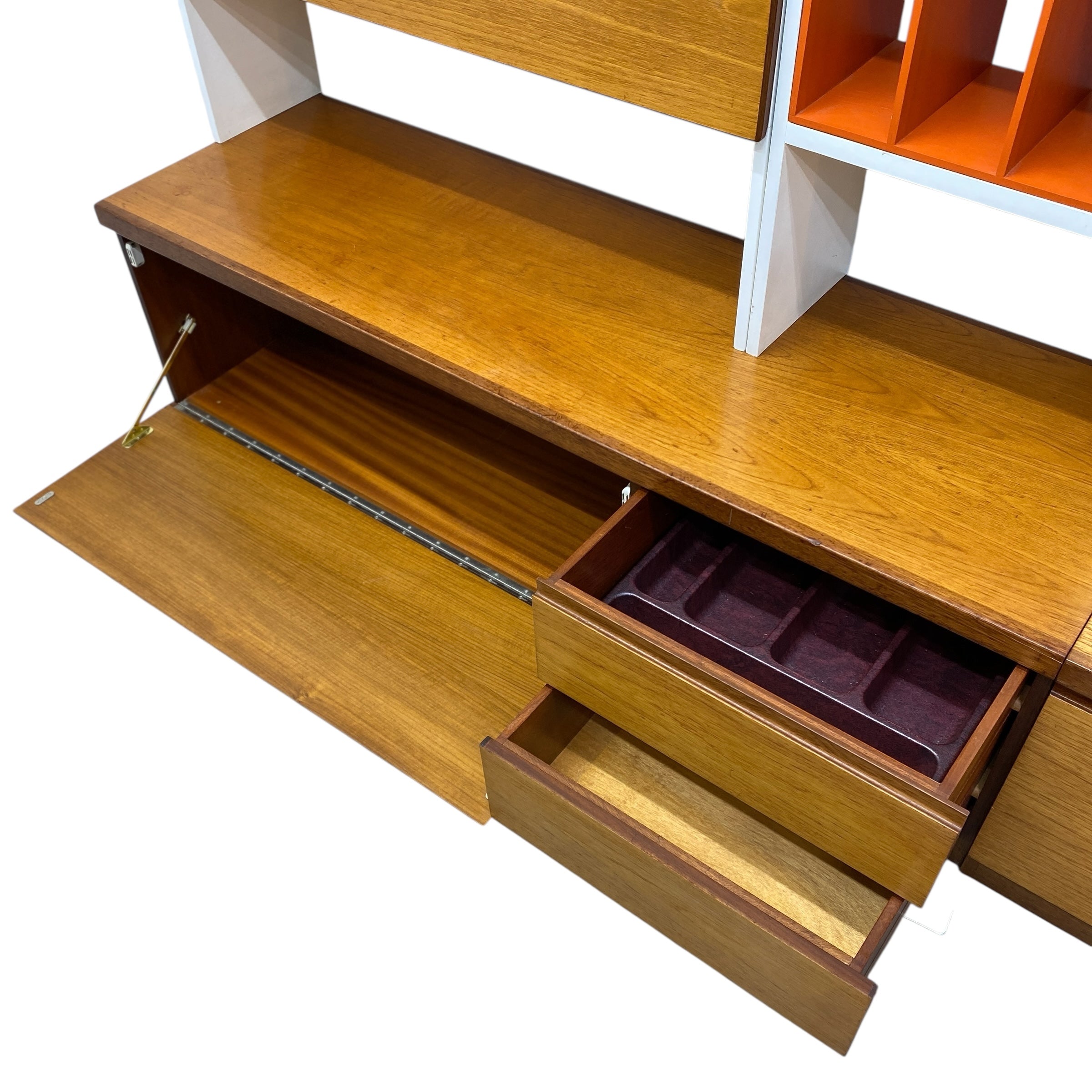 Wooden shelf with open drawer and compartments on a white background