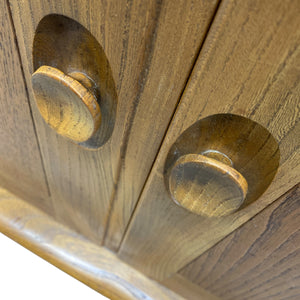Close-up of wooden cabinet with two knobs on a white background