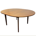 Load image into Gallery viewer, Wooden oval table with four legs on a white background
