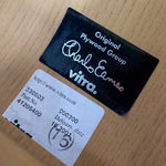 Load image into Gallery viewer, Black label with &#39;Original Plywood Group&#39; and &#39;vitra.&#39; text on a wooden surface
