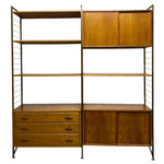 Load image into Gallery viewer, Wooden shelving unit with drawers and cabinets on a white background
