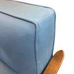 Load image into Gallery viewer, Close-up of a light blue upholstered chair with wooden armrest.
