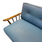 Load image into Gallery viewer, Blue cushioned chair with wooden armrest on a white background
