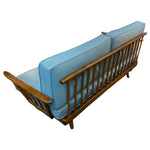 Load image into Gallery viewer, Wooden sofa with blue cushions on a white background
